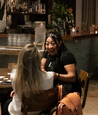 Two members laughing in conversation